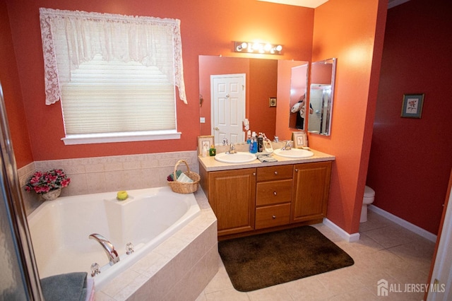 full bathroom featuring double vanity, tile patterned flooring, a sink, and a garden tub