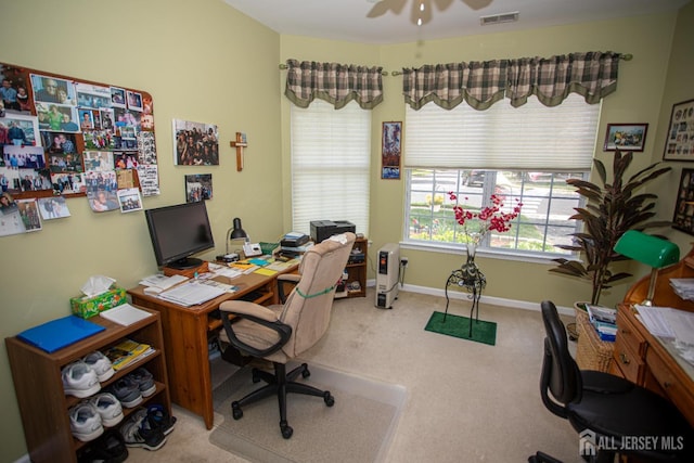 office area featuring carpet floors, a ceiling fan, baseboards, and visible vents