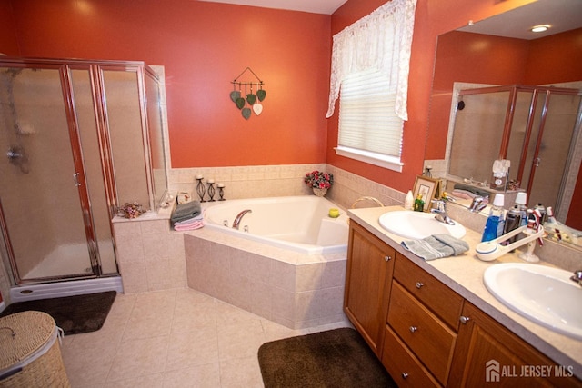 bathroom featuring a sink, a garden tub, and a stall shower