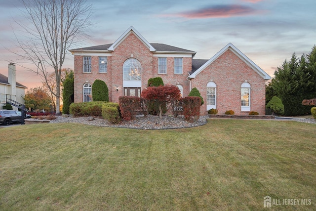 view of front of home with a lawn