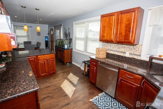 kitchen with baseboards, stainless steel dishwasher, backsplash, dark wood-style floors, and pendant lighting