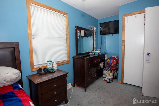 carpeted bedroom featuring baseboards