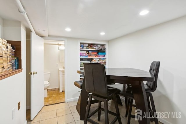 dining space with light tile patterned floors, recessed lighting, and baseboards