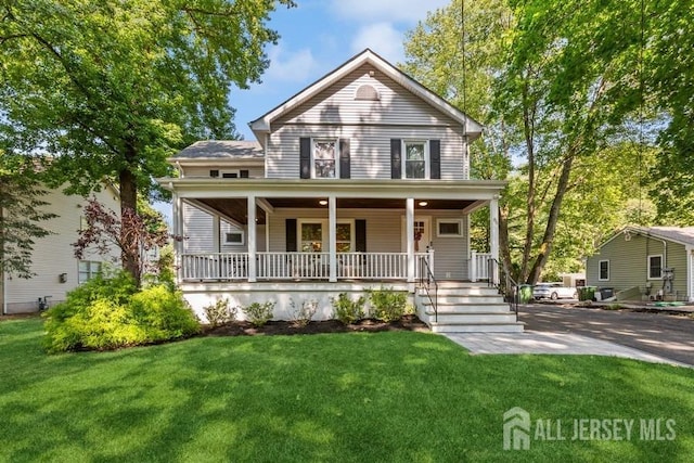 view of front facade featuring a front yard and covered porch