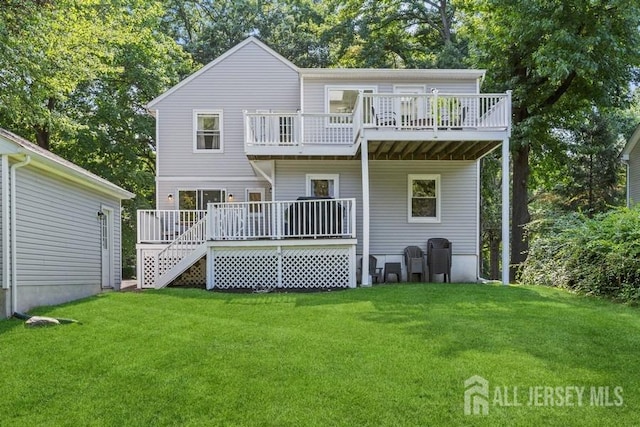 back of property featuring a deck and a yard