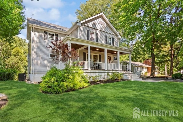 view of front of house with a front yard, covered porch, and central AC unit