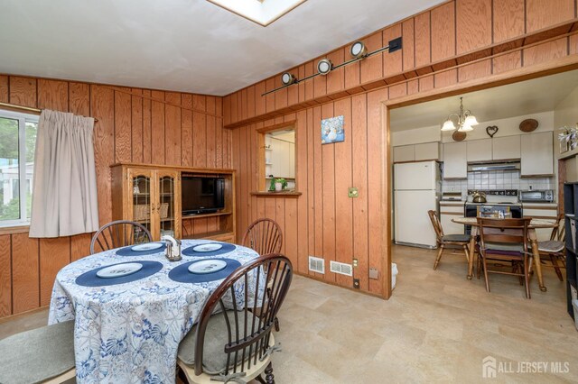 958 Apgar Ter, Rahway, NJ 07065 - dining area with wooden walls and a chandelier