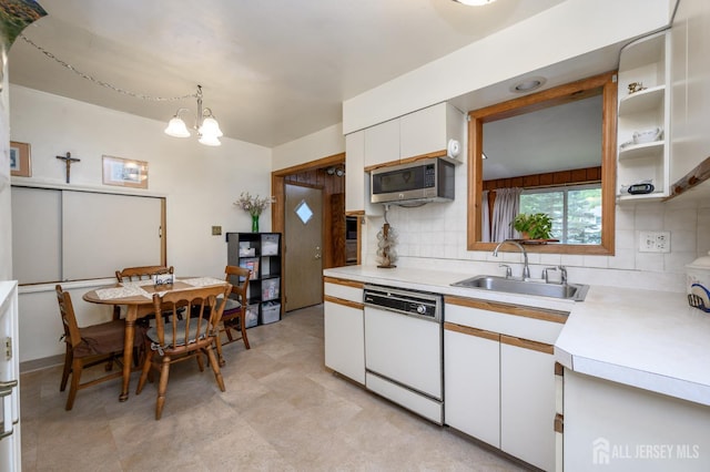 958 Apgar Ter, Rahway, NJ 07065 - kitchen featuring white dishwasher, stainless steel microwave, light countertops, white cabinets, and decorative backsplash