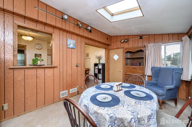 958 Apgar Ter, Rahway, NJ 07065 - dining room featuring wooden walls, a skylight, and light carpet