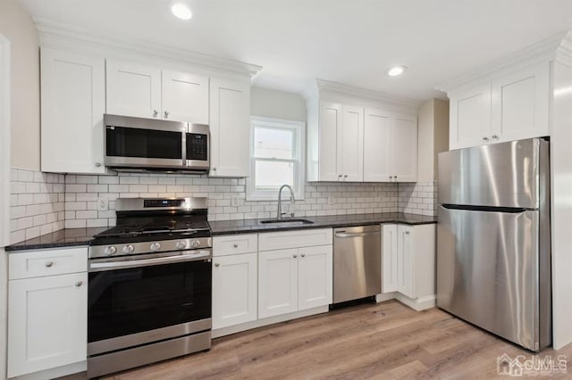 763 Prospect Ave, Old Bridge, NJ 08879 - kitchen with appliances with stainless steel finishes, light wood-type flooring, white cabinets, recessed lighting, and tasteful backsplash