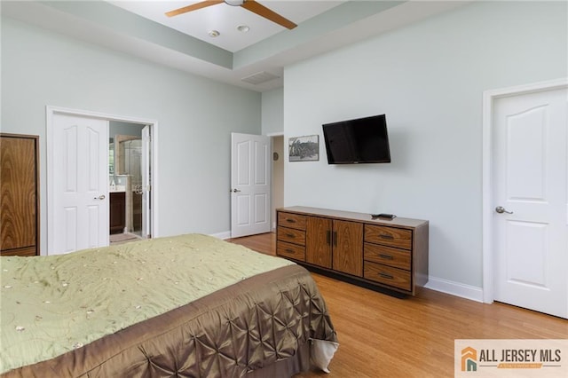 bedroom featuring visible vents, baseboards, a ceiling fan, connected bathroom, and light wood-style floors