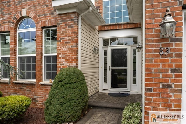 property entrance featuring brick siding