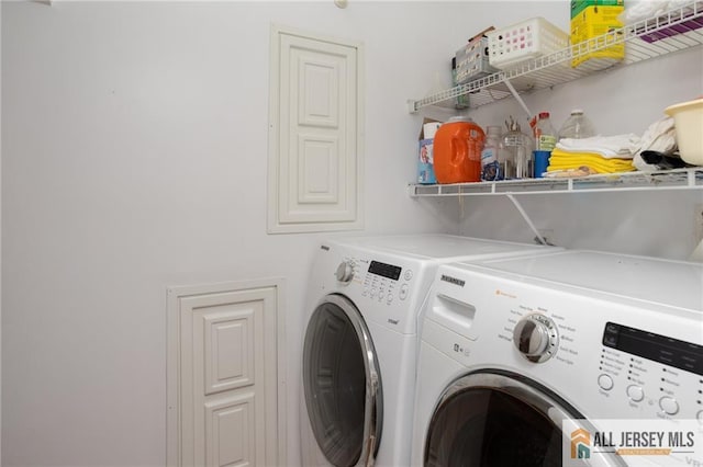 washroom with washing machine and dryer and laundry area