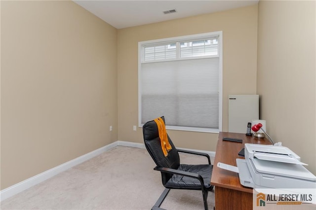 carpeted office space with visible vents and baseboards