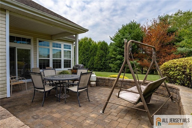 view of patio / terrace with outdoor dining area and a playground