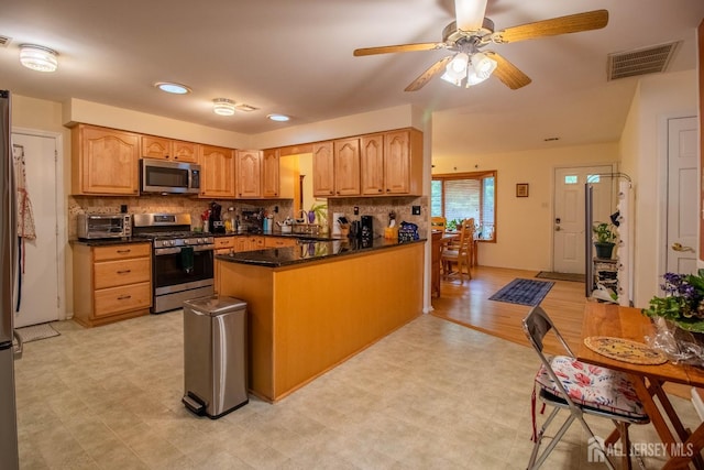 11 Drexel Ter, Monroe, NJ 08831 - kitchen featuring appliances with stainless steel finishes, a peninsula, decorative backsplash, ceiling fan, and light flooring