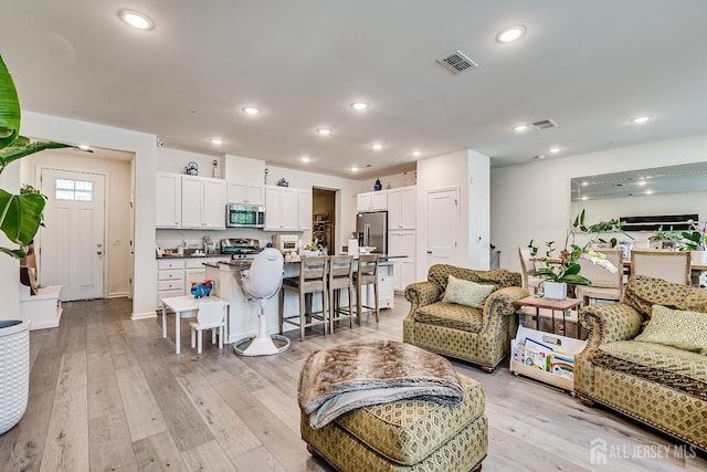 224 Park Ln, Dunellen, NJ 08812 - living room featuring light wood-style floors and recessed lighting