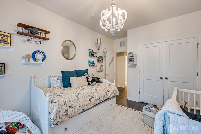 224 Park Ln, Dunellen, NJ 08812 - bedroom with dark wood finished floors, a chandelier, a closet, and baseboards