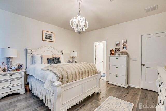 224 Park Ln, Dunellen, NJ 08812 - bedroom with a chandelier, wood finished floors, and baseboards
