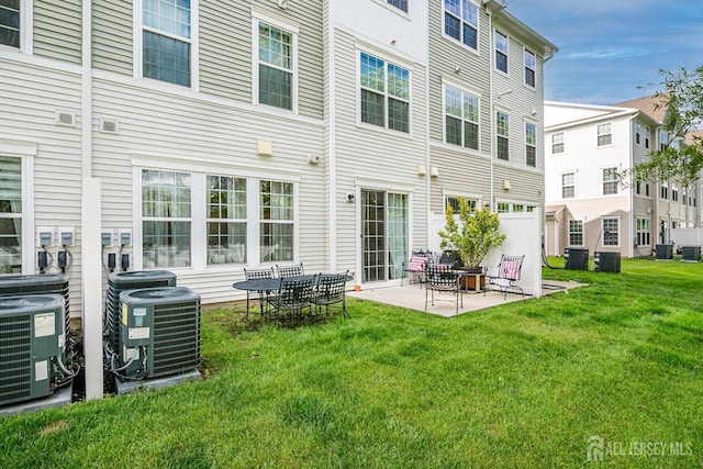 224 Park Ln, Dunellen, NJ 08812 - back of property with central AC, a lawn, and a patio