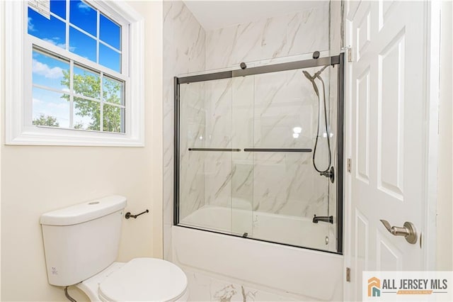 bathroom featuring shower / bath combination with glass door, toilet, and marble finish flooring