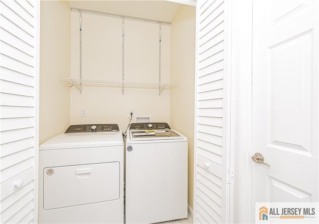 laundry area with washing machine and clothes dryer