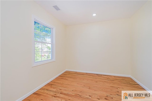 unfurnished room with light wood-type flooring, baseboards, and recessed lighting