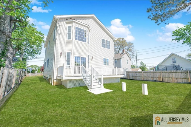 rear view of house featuring a deck