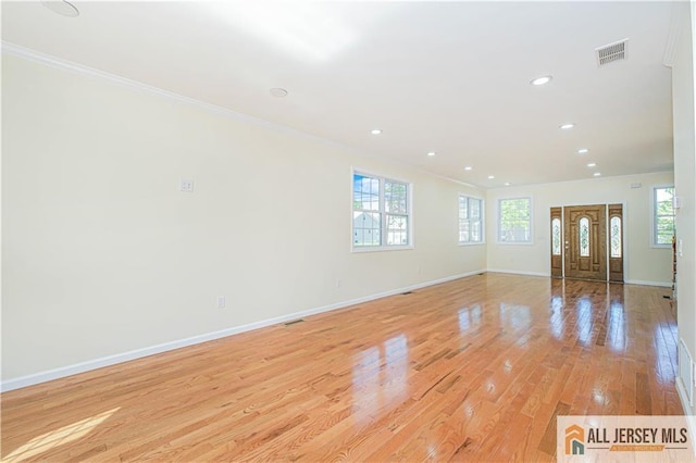 unfurnished living room with crown molding, recessed lighting, light wood-style flooring, and baseboards