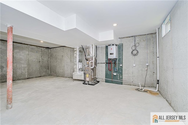 unfinished basement with water heater and heating unit