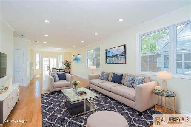 living room with healthy amount of natural light, crown molding, light wood-style floors, recessed lighting, and baseboards