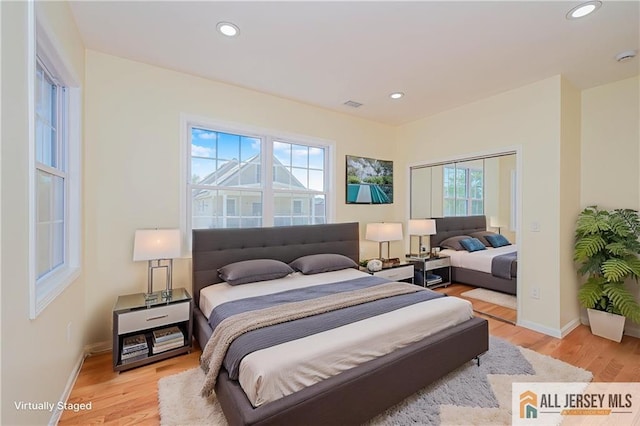 bedroom with light wood-style flooring, baseboards, and recessed lighting