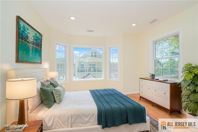 bedroom with light wood-type flooring, multiple windows, recessed lighting, and baseboards
