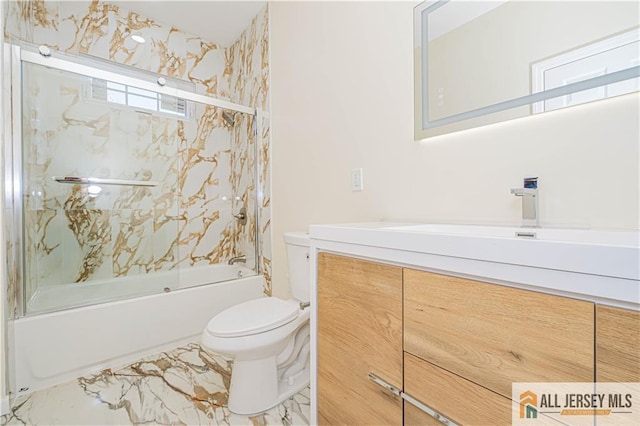 bathroom with toilet, bath / shower combo with glass door, vanity, and marble finish floors