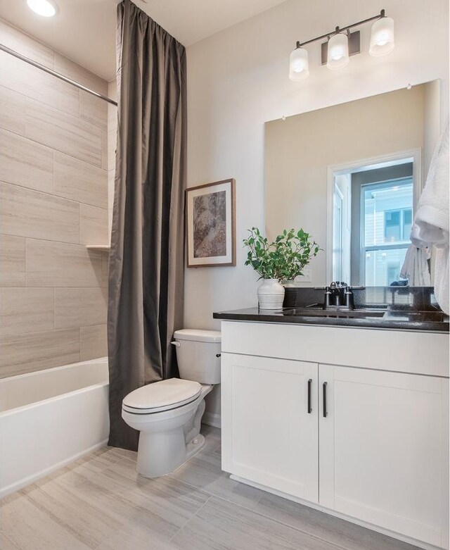 full bathroom with vanity, toilet, and shower / bath combo with shower curtain