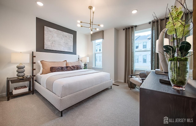 carpeted bedroom featuring a notable chandelier