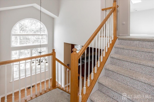 24 Hanna Ln, Old Bridge, NJ 08879 - staircase featuring a chandelier, wood finished floors, and a towering ceiling
