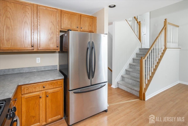 24 Hanna Ln, Old Bridge, NJ 08879 - kitchen featuring freestanding refrigerator, light wood-style flooring, stove, and brown cabinetry