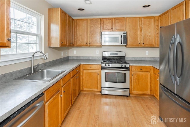 24 Hanna Ln, Old Bridge, NJ 08879 - kitchen featuring appliances with stainless steel finishes, light wood finished floors, light countertops, brown cabinetry, and recessed lighting