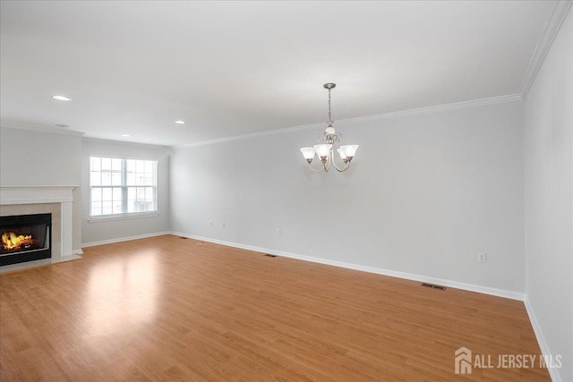24 Hanna Ln, Old Bridge, NJ 08879 - unfurnished living room featuring a chandelier, a fireplace, light wood-type flooring, crown molding, and recessed lighting