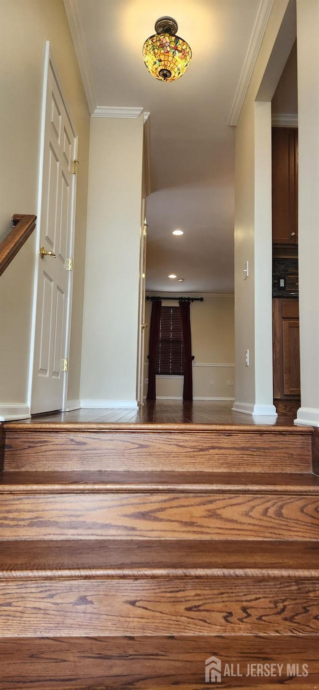 stairway featuring crown molding