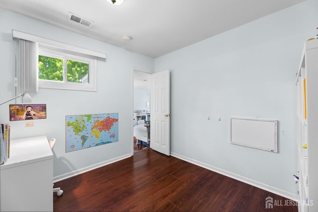 unfurnished bedroom with wood finished floors and baseboards