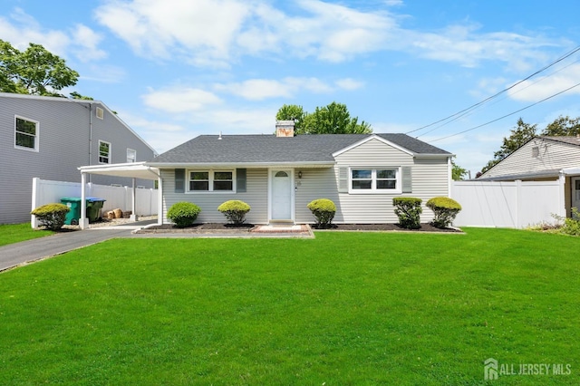 view of front of house featuring a carport, a chimney, driveway, and a shingled roof