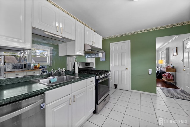 kitchen with stainless steel appliances, a sink, under cabinet range hood, and white cabinets