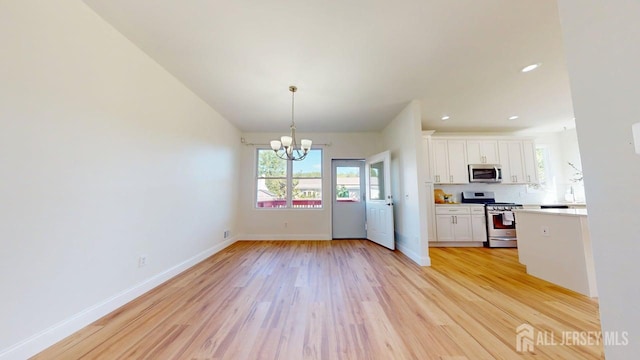 15-A Avenue B, Helmetta, NJ 08828 - kitchen with appliances with stainless steel finishes, white cabinets, a chandelier, light wood finished floors, and recessed lighting