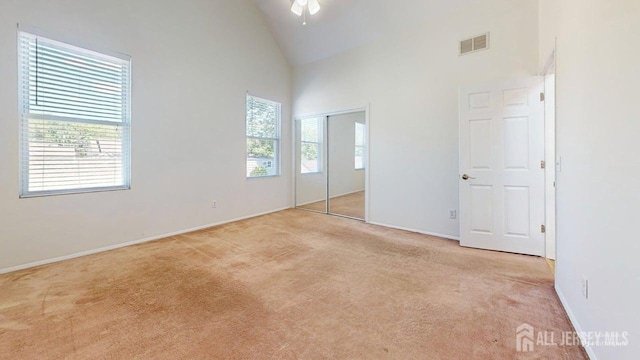 15-A Avenue B, Helmetta, NJ 08828 - unfurnished bedroom with carpet floors, high vaulted ceiling, baseboards, and a closet
