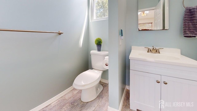 15-A Avenue B, Helmetta, NJ 08828 - bathroom featuring toilet, vanity, wood finished floors, and baseboards