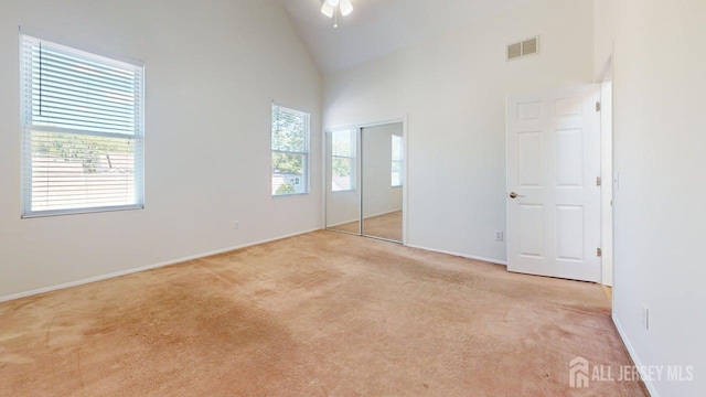 15-A Avenue B, Helmetta, NJ 08828 - unfurnished bedroom featuring light carpet, high vaulted ceiling, baseboards, and a closet