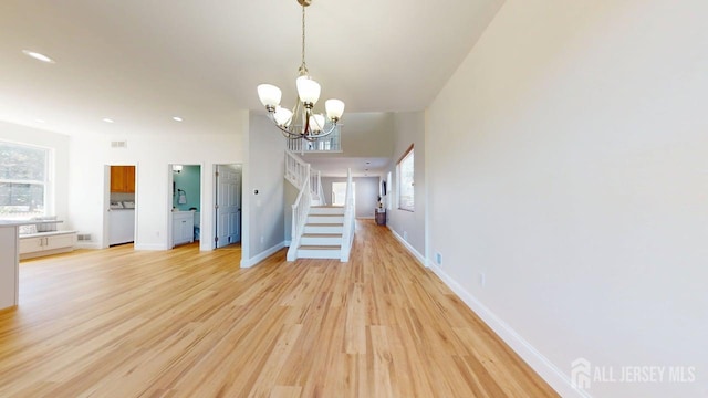 15-A Avenue B, Helmetta, NJ 08828 - unfurnished dining area with a chandelier, washer / dryer, stairs, light wood finished floors, and baseboards