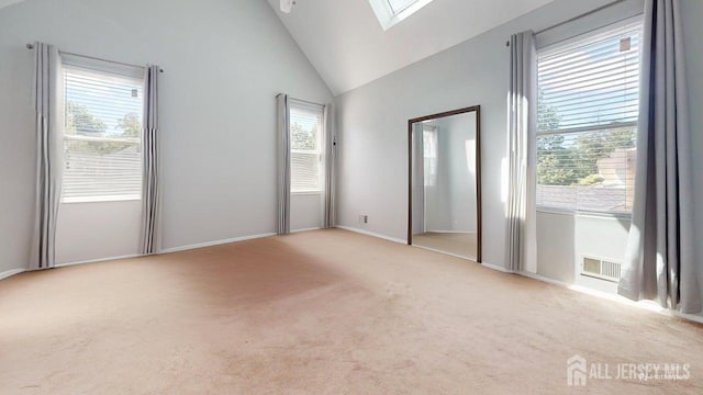 15-A Avenue B, Helmetta, NJ 08828 - spare room featuring a skylight, carpet floors, high vaulted ceiling, and baseboards